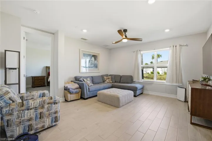 Living room featuring ceiling fan, light wood-style floors, and recessed lighting