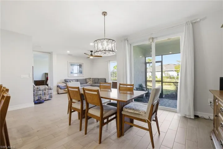 Dining area with light wood finished floors and a chandelier