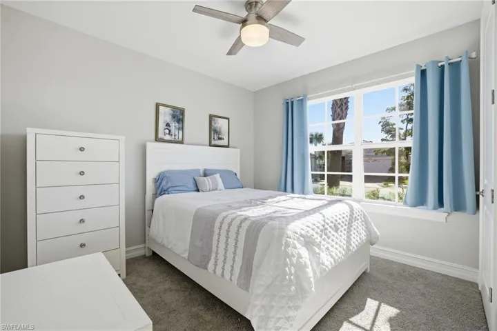 Bedroom featuring a ceiling fan and carpet flooring