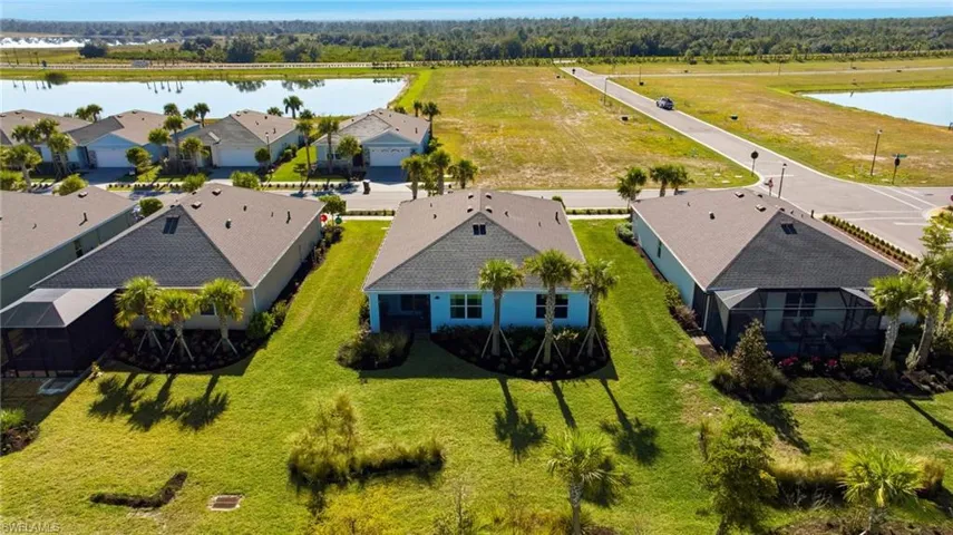 Aerial perspective of suburban area featuring a nearby body of water