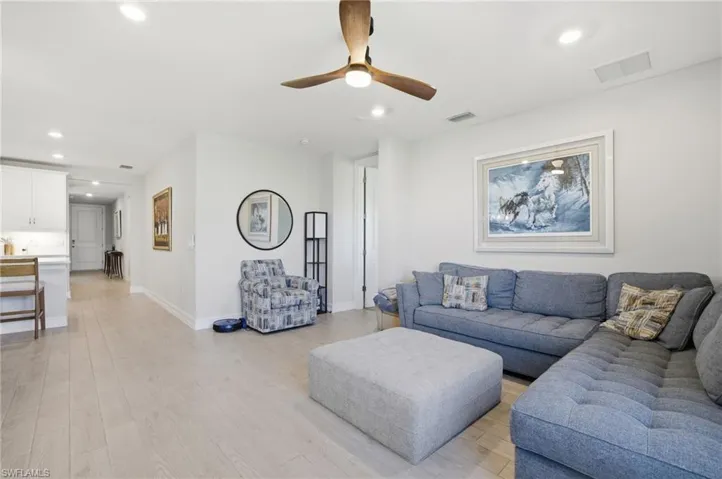 Living area featuring light wood-type flooring, recessed lighting, and ceiling fan