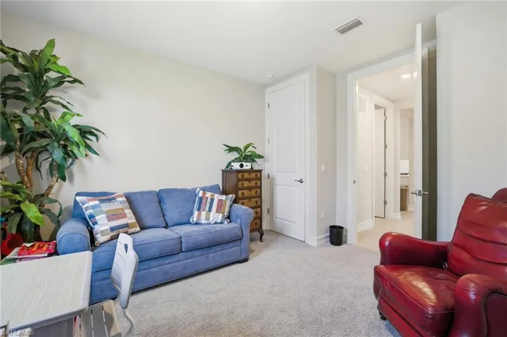 Living room featuring light carpet and baseboards