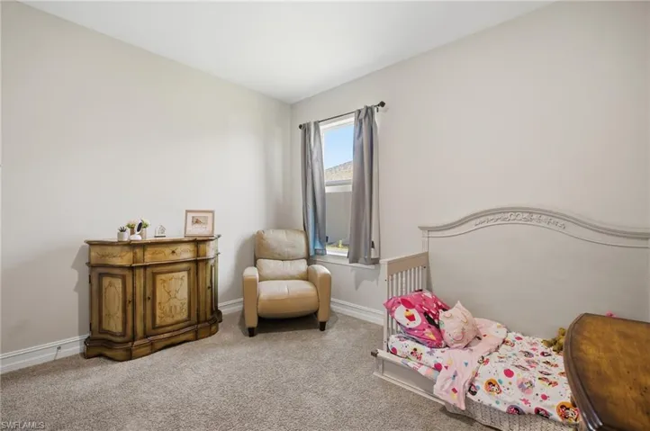 Bedroom with carpet floors and baseboards