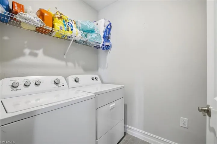Laundry room featuring washing machine and dryer and light wood-style flooring