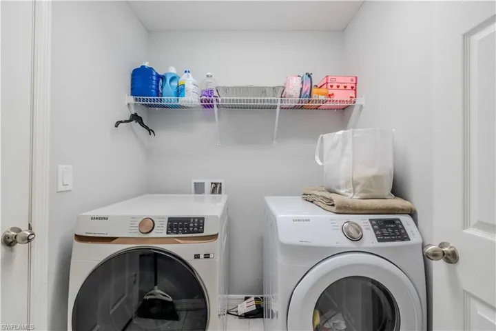 Washroom featuring washing machine and dryer