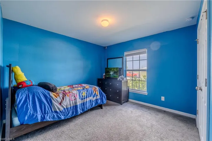Bedroom with carpet floors and baseboards
