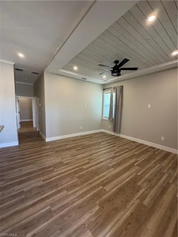 Spare room featuring wooden ceiling, dark wood-style flooring, ceiling fan, and recessed lighting