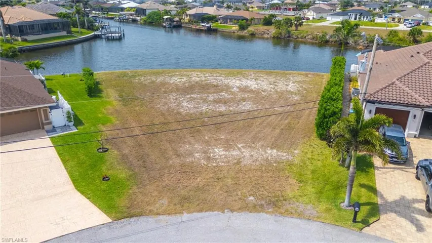 Drone / aerial view with a water view and a residential view