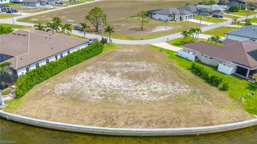 Drone / aerial view with a residential view and a water view