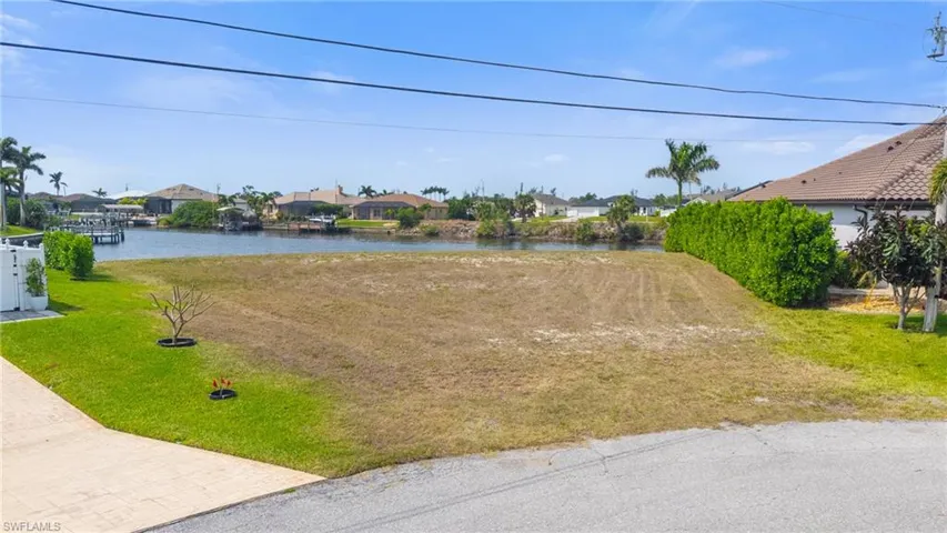 View of yard featuring a residential view and a water view