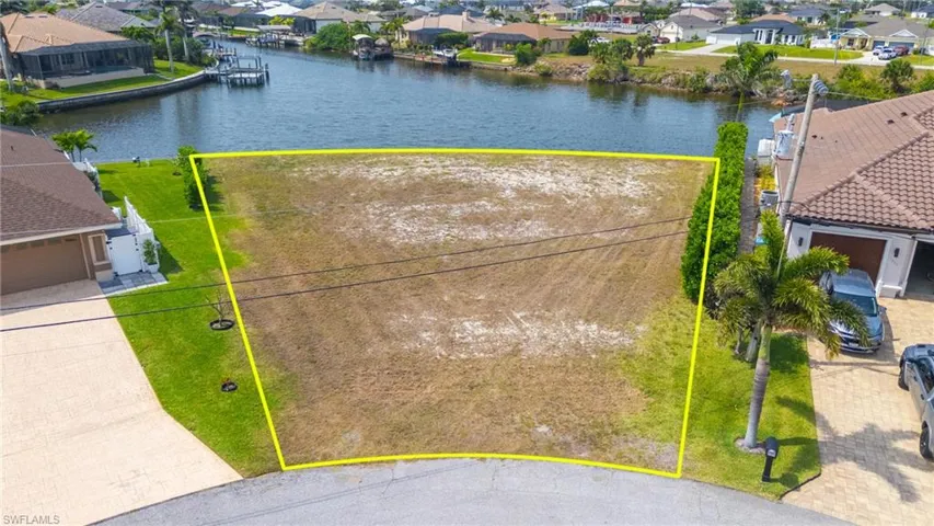 Birds eye view of property with a residential view and a water view