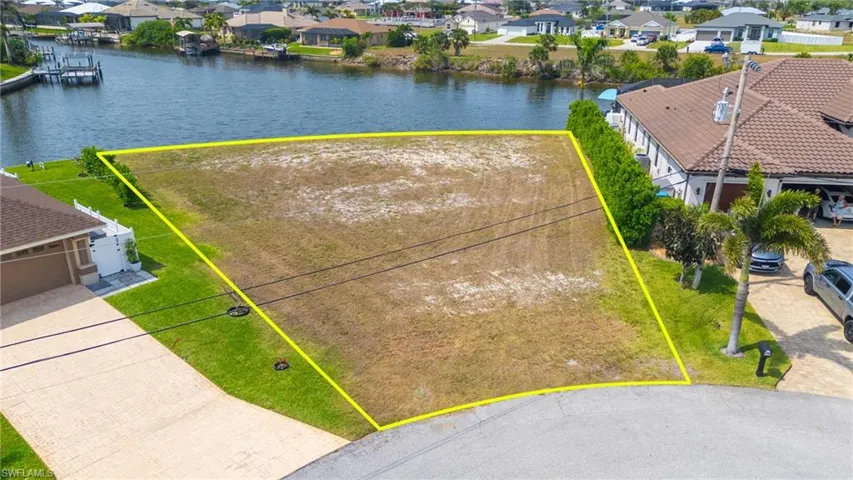 Birds eye view of property with a residential view and a water view