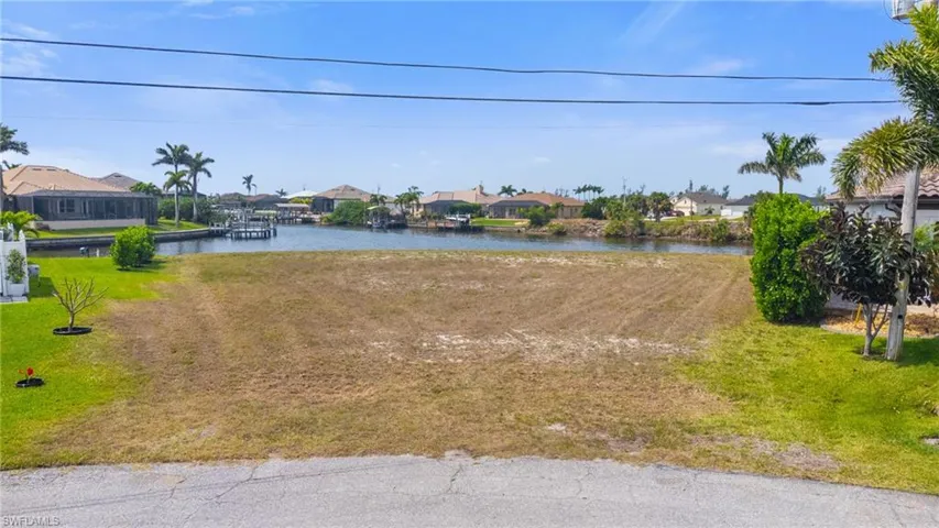 View of yard with a residential view and a water view