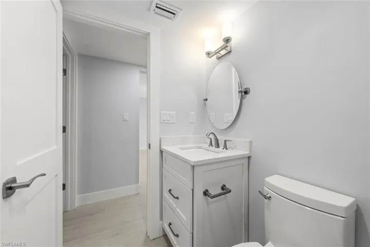 Full bathroom with vanity and a marble finish shower