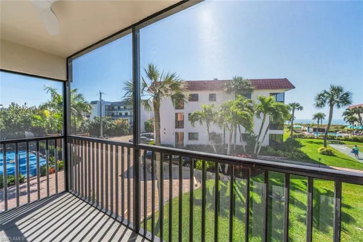 Balcony featuring a sunroom and a ceiling fan