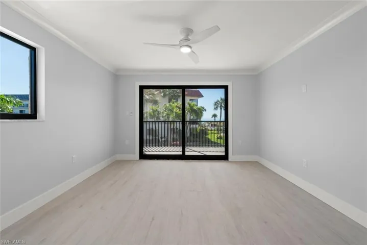 Unfurnished room featuring crown molding, a ceiling fan, and light wood-style flooring