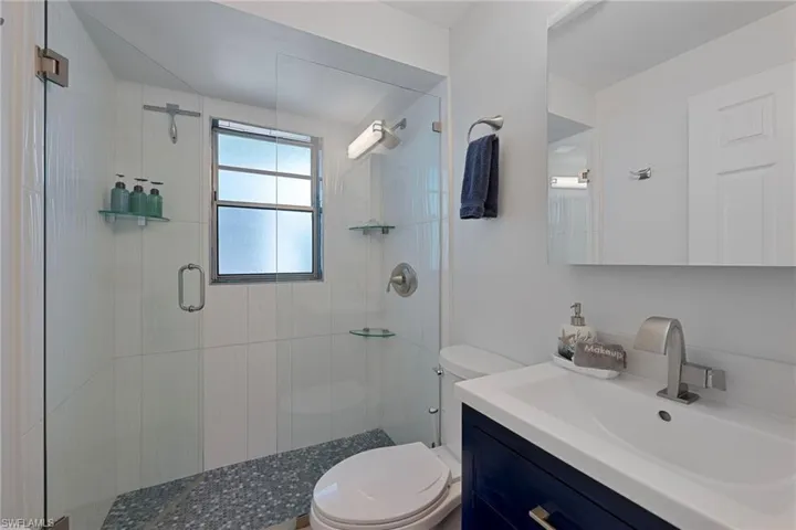 Full bath with vanity and a shower stall