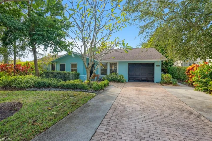 Ranch-style house with stucco siding, decorative driveway, and an attached garage