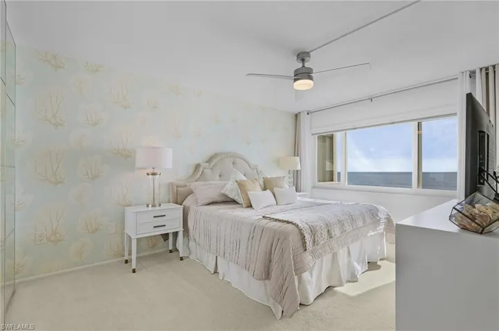Carpeted bedroom with ceiling fan