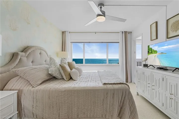 King bed with 2 nightstands, door to balcony.