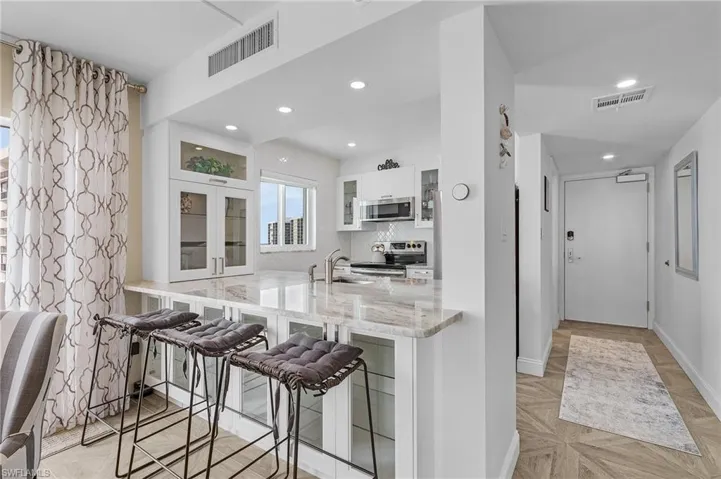 Completed upgraded kitchen features plenty of storage with glass paneled cabinet doors, gorgeous quartz countertops, backsplash, stainless appliances and more.