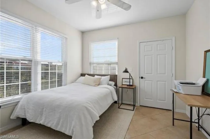 Bedroom featuring light tile patterned flooring and ceiling fan