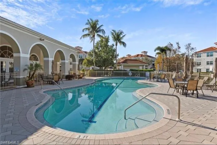 Community pool with a patio
