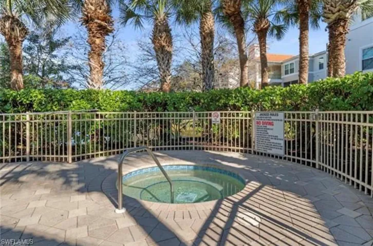 View of pool with a hot tub and a patio