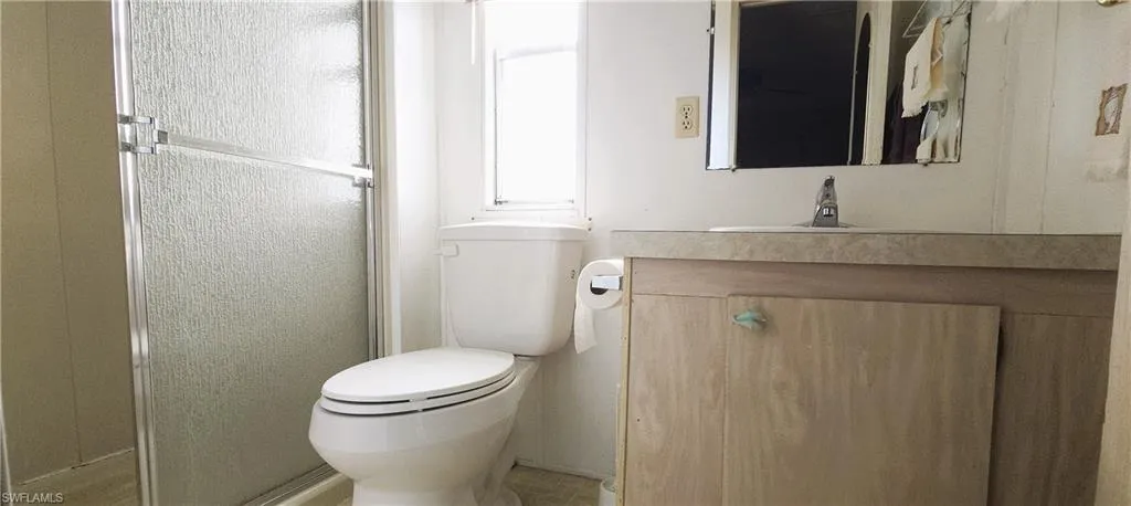 Full bathroom with vanity, toilet, a shower stall.
