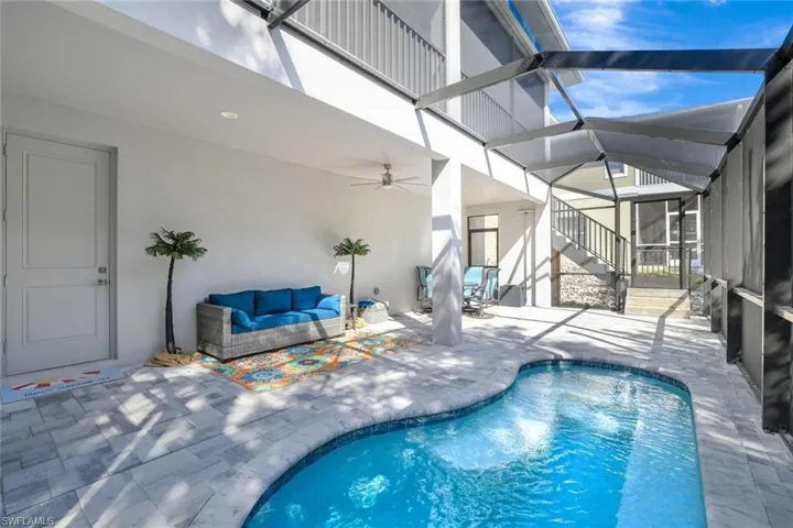 Pool with a patio, an outdoor hangout area, and a lanai