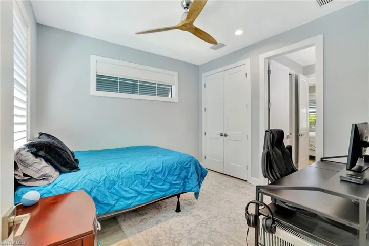 Bedroom with a closet, visible vents, recessed lighting, and a ceiling fan