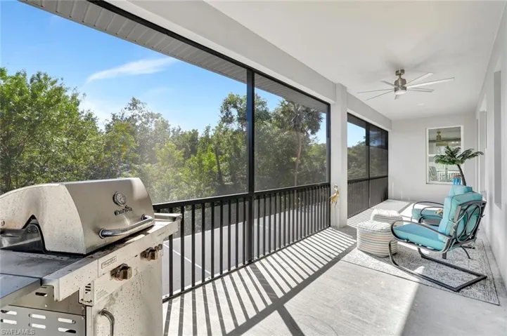Sunroom featuring area for grilling and ceiling fan