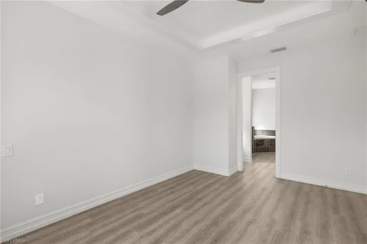 Unfurnished room featuring ceiling fan and light hardwood / wood-style floors