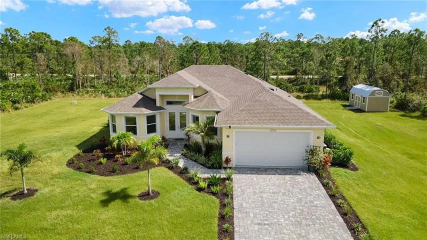 View of front of property with a front yard and a garage