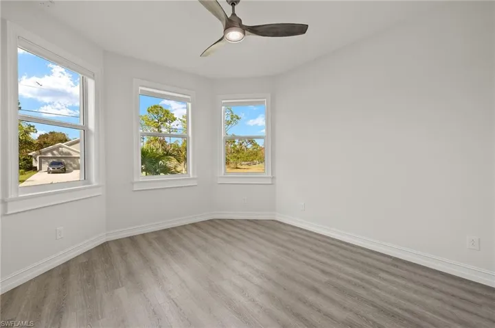 Spare room with plenty of natural light, light hardwood / wood-style flooring, and ceiling fan