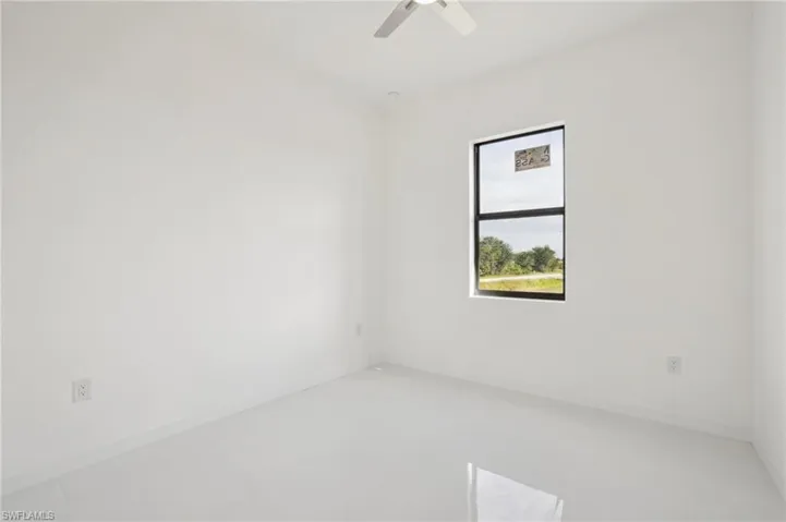 Empty room with a ceiling fan and baseboards