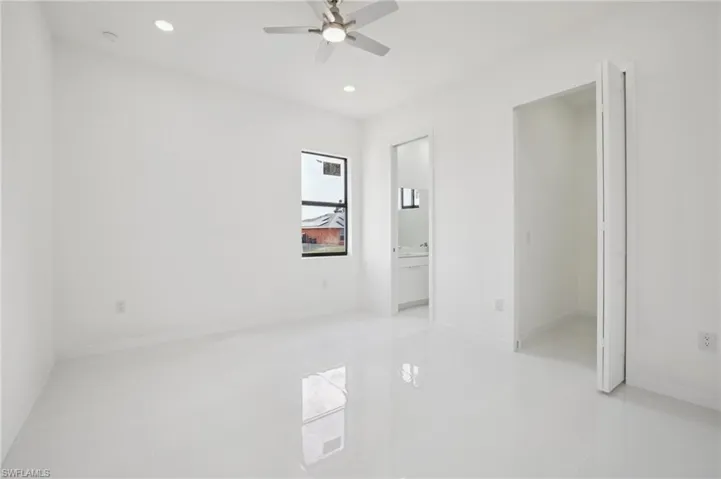 Spare room featuring recessed lighting, light tile patterned floors, and a ceiling fan