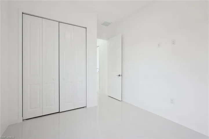 Unfurnished bedroom with a closet and tile patterned flooring