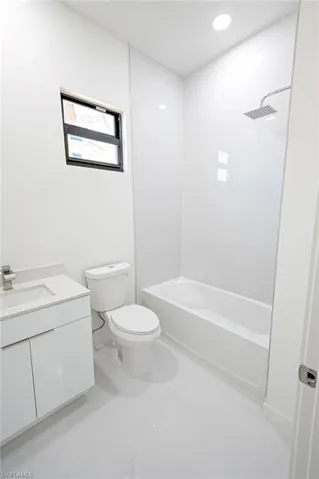 Bathroom with shower / tub combination and vanity