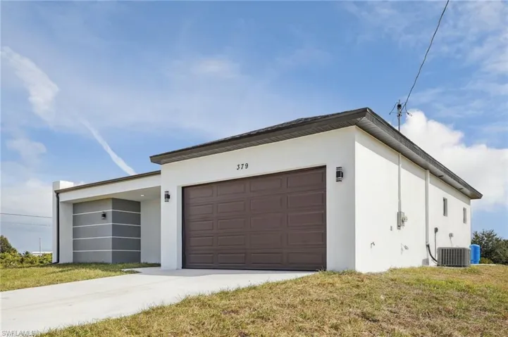 Garage featuring concrete driveway