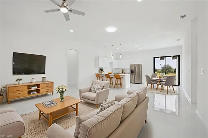 Virtually Staged- Living room featuring ceiling fan, recessed lighting, and light tile patterned flooring