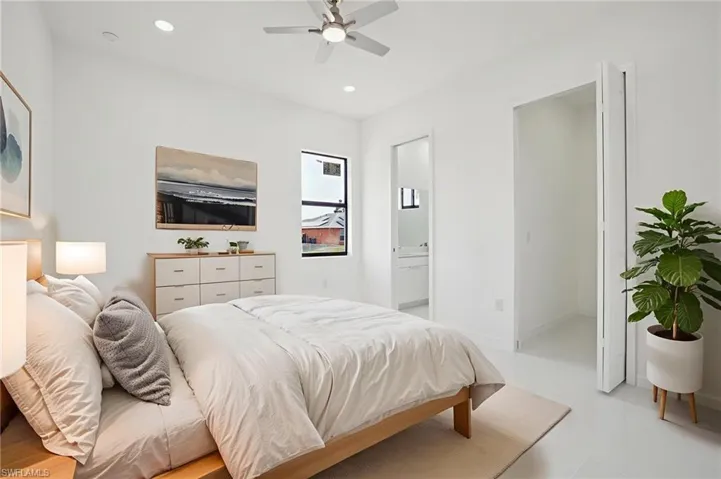 Virtually staged- Bedroom with ceiling fan, recessed lighting, and connected bathroom