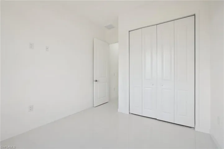 Unfurnished bedroom with a closet and baseboards