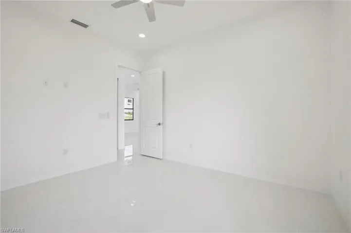 Empty room featuring recessed lighting, light tile patterned floors, and a ceiling fan