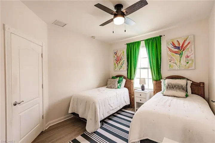 Bedroom with wood-type flooring and ceiling fan