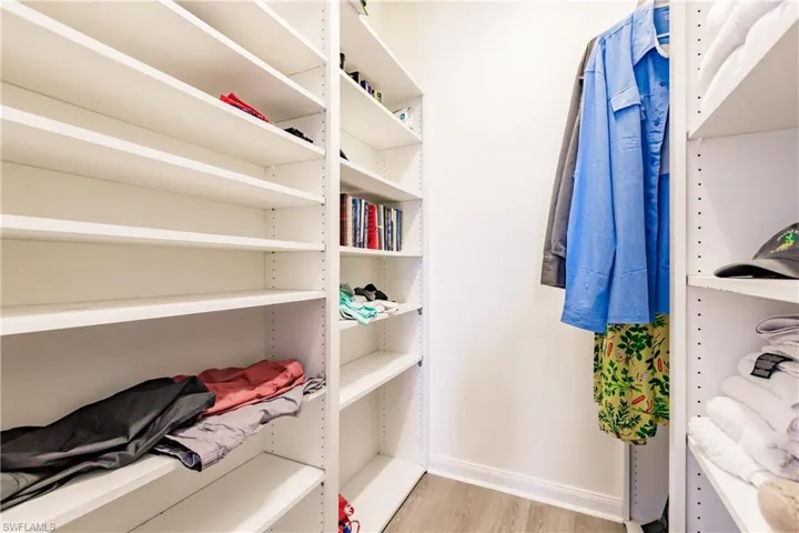 Spacious closet featuring light hardwood / wood-style floors