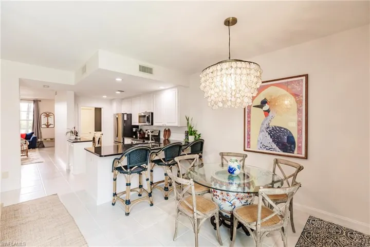 Dining space featuring light tile patterned floors and a chandelier