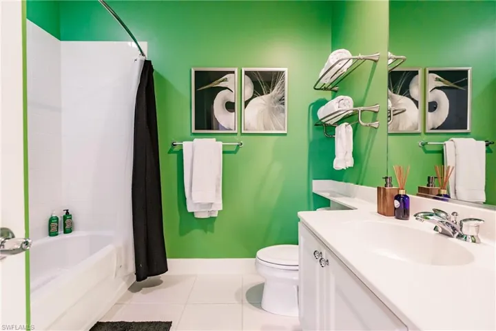 Full bathroom featuring vanity, tile patterned floors, toilet, and shower / tub combo