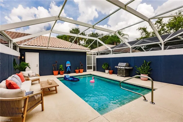 View of pool with grilling area, a patio, and a lanai