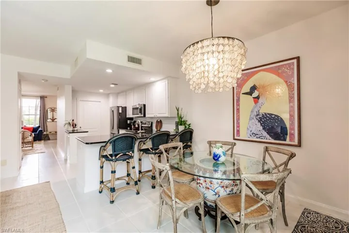 Tiled dining area featuring a chandelier